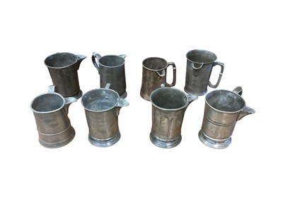 Lot 3106 - Collection of eight 19th century pewter Quart tavern jugs, each with pub / tavern names engraved to bases, (8).