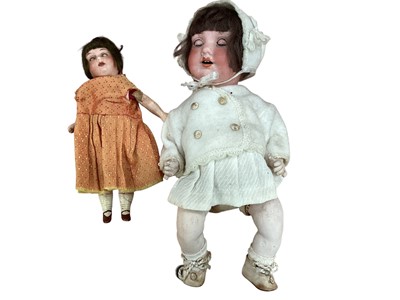 Lot 2004 - Two antique German bisque porcelain dolls both clothed. The larger doll with impressed mark to head 'Germany A. 410. M, the smaller doll 'Germany A. 1210. M'