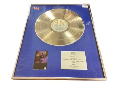 Lot 2737 - Silver presentation disc mounted in glazed frame with plaque - Presented to Tim Foster to recognise sales in the United Kingdom of more than 60,000 copies of the A&M album 'Cry Tough' 1979