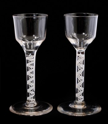 Lot 30 - Two 18th century double series opaque twist stem wine glasses with ogee bowls, 14.5cm high