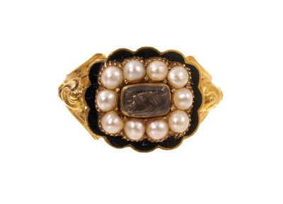 Lot 408 - William IV gold enamel and pearl mourning ring with a central glazed compartment of platted hair surrounded by a border of seed pearls on black enamel ground, the split shoulders with cast folia...
