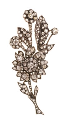 Lot 410 - Victorian diamond floral spray brooch with a large central flower with further floral clusters and foliage, all set with old cut and rose cut diamonds in silver setting on gold, estimated total...
