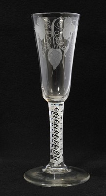 Lot 11 - 18th century glass ale flute, the tall round funnel bowl engraved with hops and barley, over a double series opaque twist stem, on a conical foot, 18.75cm high