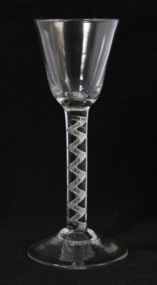 Lot 10 - 18th century air twist wine glass, the round funnel bowl over a plain stem with spiral cable, on a high conical foot, 16.25cm high