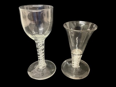 Lot 8 - 18th century wine glass, the round funnel bowl over a double series opaque twist stem, and a continental opaque twist stem firing glass, 11.5cm and 15cm (2)