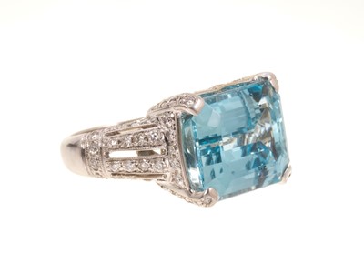 Lot 431 - A fine aquamarine and diamond ring with a rectangular step-cut aquamarine measuring approximately 15.7mm x 13.1mm x 8.2mm in 18ct white gold setting with pavé set diamonds to the pierced gallery...
