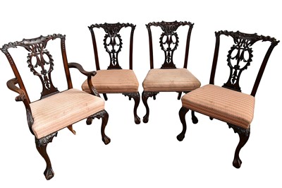 Lot 1425 - Good set of four Chippendale revival carved mahogany dining chairs, with elaborate carved and pierced backs and stuffover seat on carved cabriole legs, to include one elbow chair