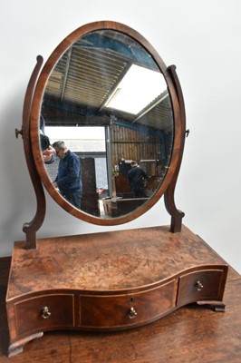 Lot 1454 - George III mahogany serpentine toilet mirror, with oval hinged plate and three drawers to the platform base on bracket feet, 43cm wide