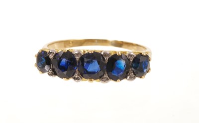 Lot 513 - Victorian sapphire five stone ring with five graduated mixed-cut blue sapphires in a carved gold claw setting with diamond accents to the claws, on tapered gold shank, ring size Q½.