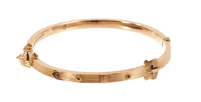 Lot 515 - Victorian 9ct rose gold hinged bangle with belt and buckle design