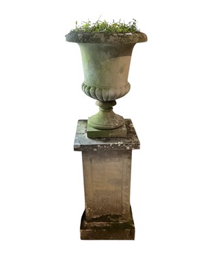 Lot 1539 - Weathered classical form garden urn, 70cm high, raised on square pedestal, total height approximately 157cm