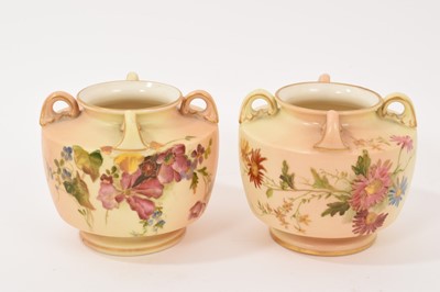 Lot 108 - Pair of early 20th century Royal Worcester blush ivory vases, each of squat form with four lug handles, 8cm high