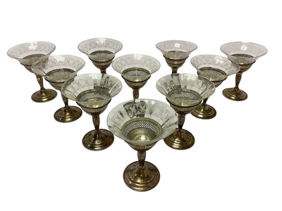 Lot 333 - Ten champagne glasses with etched glass bowls and white metal pedestal stems