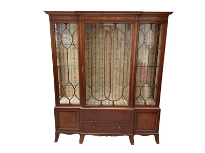Lot 1543 - Edwardian satinwood and barber pole strung breakfront bookcase, with stepped cornice and enclosed above by three glazed doors, with two drawers to the base and flaming cupboards, on splayed brac...
