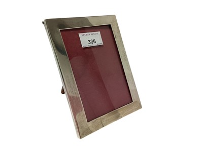 Lot 336 - 1920s silver photograph frame of plain rectangular form, with wooden easel back, (marks rubbed), 16.5cm high