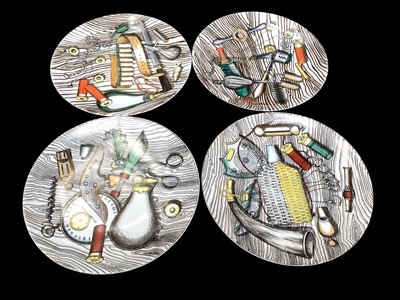 Lot 2213 - Set of four Piero Fornasetti porcelain plates decorated with items relating to hunting