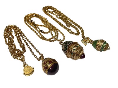 Lot 13 - Vintage Edgar Berebi gilt metal necklace with enamelled egg shaped pendant, together with two other similar style pendant necklaces (3)