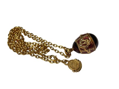 Lot 13 - Vintage Edgar Berebi gilt metal necklace with enamelled egg shaped pendant, together with two other similar style pendant necklaces (3)