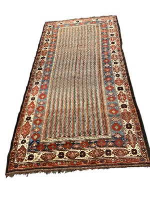 Lot 1571 - Antique Caucasian rug, having gemontric rows in flowerhead borders, 325 x 160cm