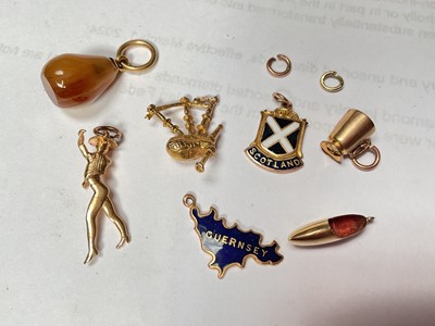 Lot 96 - 9ct gold charm bracelet with a good collection of gold and yellow metal charms including a George V half sovereign, 1913.