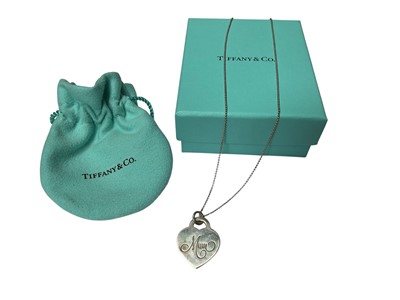 Lot 99 - Tiffany & Co silver heart tag pendant engraved 'Mum' on a Tiffany & Co silver ball chain, 40.5cm long, with pouch and box