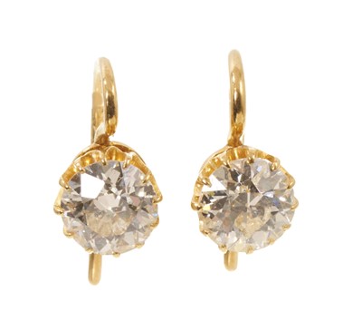 Lot 647 - Pair of Victorian diamond drop earrings, each with an old cut diamond in gold coronet claw setting with hook fittings