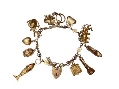 Lot 54 - 9ct gold charm bracelet with various novelty charms and a padlock clasp