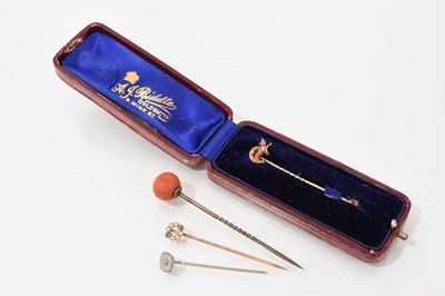 Lot 704 - Four stick pins