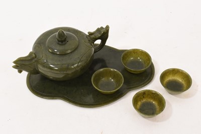 Lot 964 - Chinese Jade or green hardstone teaset comprising teapot and four tea bowls on shaped tray