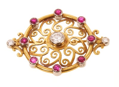Lot 615 - Circular diamond and gem set brooch with scroll motif