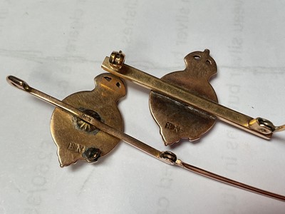 Lot 41 - Pair of gold enamelled bar brooches, both with makers mark BN, and a paste set white metal floral brooch (3)
