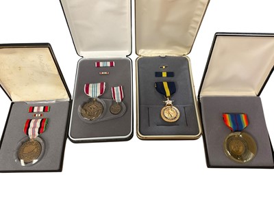 Lot 798 - Group of four American medals in boxes to include a Defence Meritorious Service medal, United States Navy Distinguished Service medal, World War I 75th Anniversary Medal and an Afghanistan Campa...