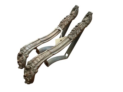 Lot 5048 - A pair of rococo-style bronze curtain tiebacks, late 19th century, each cast with acanthus leaves and shells, signed 'P D' to the reverse, 5cm wide, 15cm deep, 27cm high (2) Provenanc...