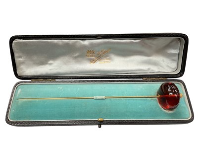 Lot 42 - Victorian amber hat pin with a large polished amber bead terminal on a gilt metal pin, in original fitted case
