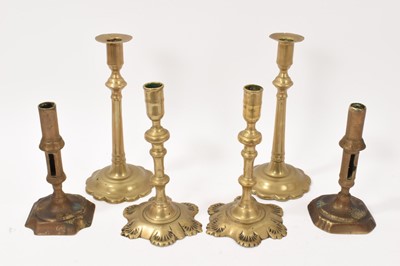 Lot 912 - Two pairs of early 18th century cast brass candlesticks, and a near pair. (6)