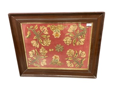 Lot 2553 - Collection of 17th century floral and foliate stump work fragments, in glazed frame