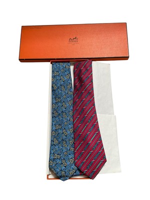 Lot 2553 - Two Hermès silk ties, blue and yellow ribbons 7170 FA red and blue French flag Bastille Day 7171FA, in one box