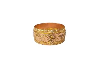 Lot 114 - Edwardian 9ct rose gold wedding ring with foliate engraved band