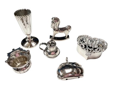 Lot 60 - Silver heart shaped trinket box with pierced butterfly and foliate decoration to the cover (London 1911), together with a contemporary silver rocking horse pin cushion, and other small plated it...