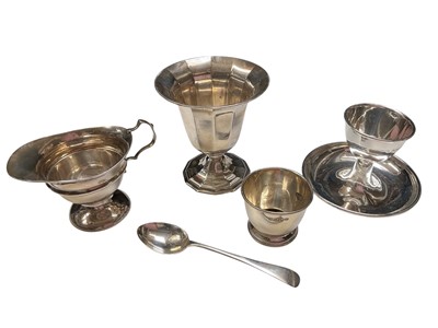 Lot 150 - Group of silver to include a cream jug, two egg cups, teaspoon and a pedestal vase with weighed base (5)