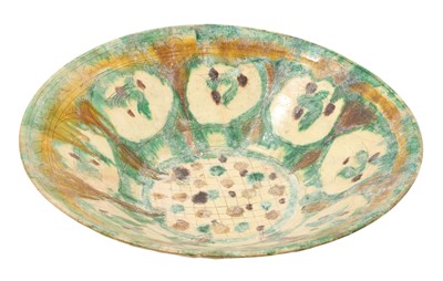 Lot 209 - 11th-12th century Islamic Iranian Nishapur pottery bowl - with cream glaze, the interior with incised birds and chequering and green, yellow and brown decoration, 34cm diameter x 9cm high