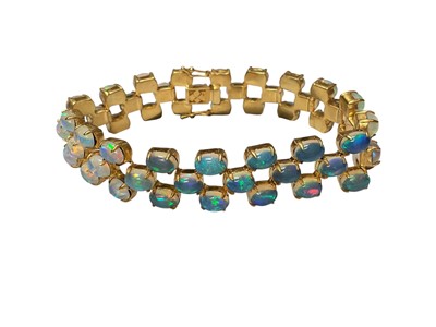 Lot 7 - Contemporary opal bracelet with 54 oval opal cabochons in a three row brick link design in silver gilt setting, 18cm long
