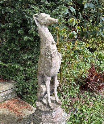 Lot 1355 - Pair of garden statues of seated greyhounds