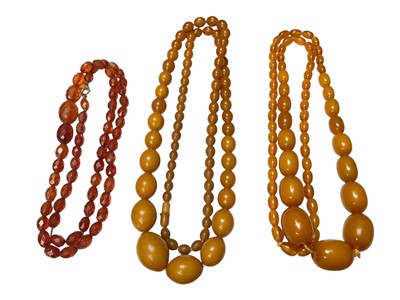 Lot 164 - Antique faceted amber bead necklace with gold plated clasp and two vintage simulated amber / Bakelite bead necklaces