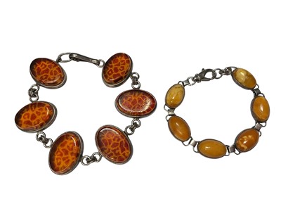 Lot 165 - Russian silver mounted amber bracelet and a Russian silver mounted designer bracelet with amber coloured panels (2)