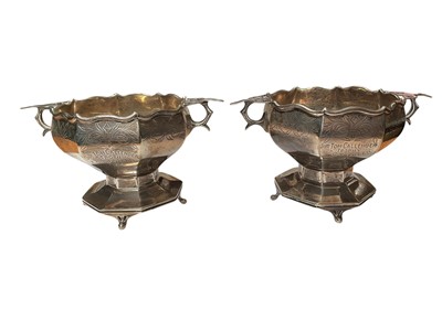 Lot 36 - Pair of 1920s silver two handled pedestal bowls with engraved decoration and presentation inscriptions (London 1928), 7cm high x 13.5cm overall width