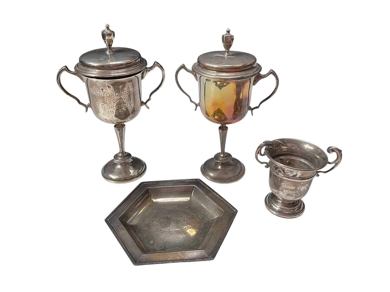 Lot 37 - Two similar silver two handled trophy cups with covers, miniature silver two handled trophy cup and a silver hexagonal dish, mostly with engraved presentation inscriptions