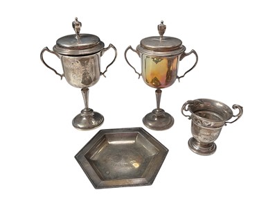 Lot 37 - Two similar silver two handled trophy cups with covers, miniature silver two handled trophy cup and a silver hexagonal dish, mostly with engraved presentation inscriptions
