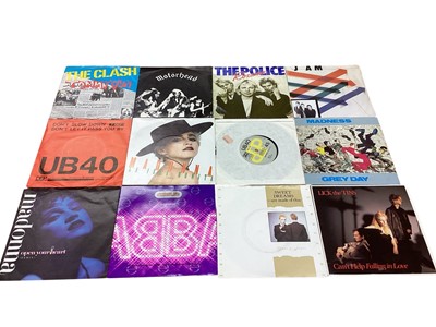 Lot 2703 - Two vintage cases of 7" single records including UB40, The Clash, Motörhead, Dire Straits, The Jam, Madness, The Police, Madonna etc