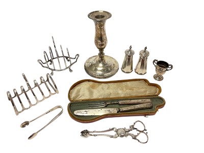 Lot 410 - Various silver including two toast racks, candlestick, pair of pepperettes, sm...